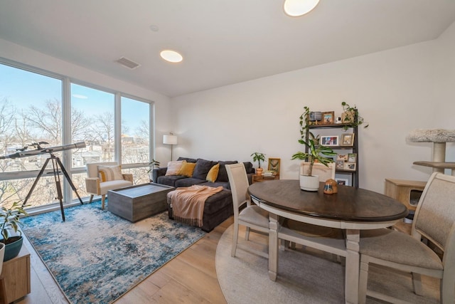 living area featuring visible vents and light wood finished floors