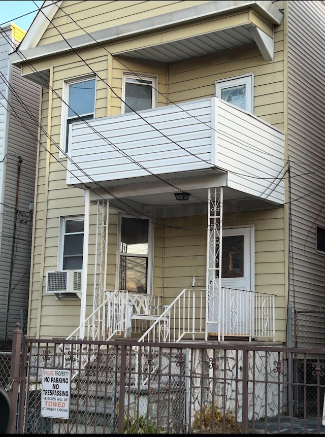 view of exterior entry featuring a balcony