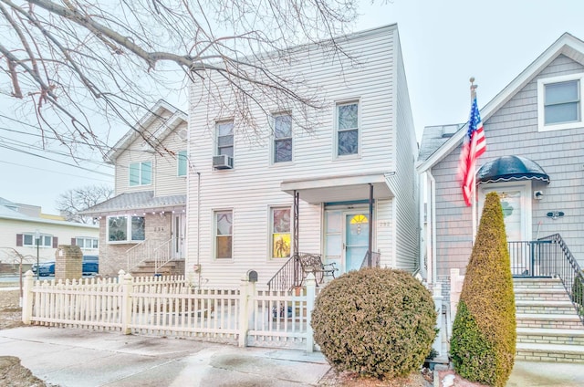 view of front of house featuring a fenced front yard and cooling unit