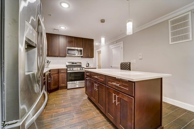 2765 Kennedy Blvd Unit 1, Jersey City, NJ 07306 - kitchen featuring stainless steel appliances, ornamental molding, wood finish floors, light countertops, and hanging light fixtures