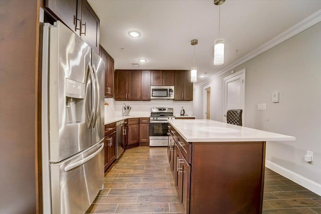 2765 Kennedy Blvd Unit 1, Jersey City, NJ 07306 - kitchen featuring appliances with stainless steel finishes, ornamental molding, wood finish floors, light countertops, and a kitchen island