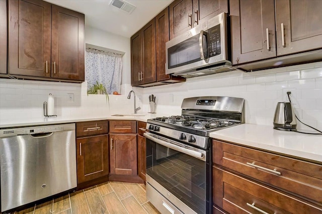 2765 Kennedy Blvd Unit 1, Jersey City, NJ 07306 - kitchen featuring stainless steel appliances, decorative backsplash, light countertops, and light wood-style flooring