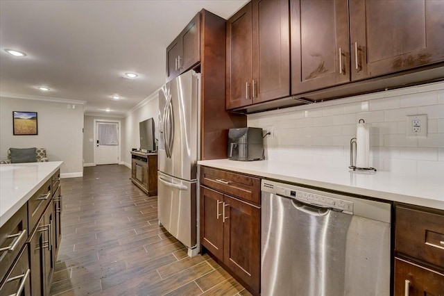 2765 Kennedy Blvd Unit 1, Jersey City, NJ 07306 - kitchen with appliances with stainless steel finishes, ornamental molding, tasteful backsplash, light countertops, and recessed lighting