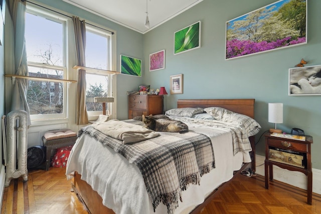 bedroom with ornamental molding and parquet floors