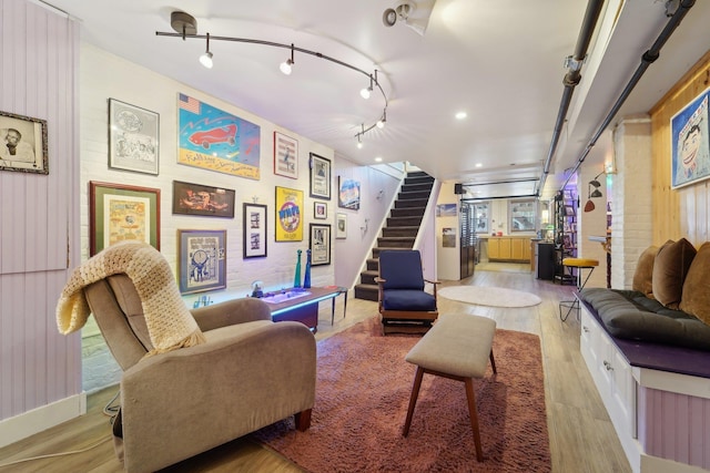 interior space featuring rail lighting and light hardwood / wood-style flooring