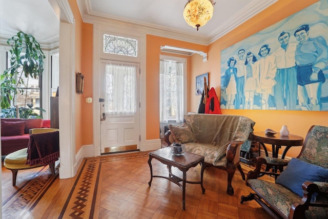 living area with crown molding and light parquet flooring