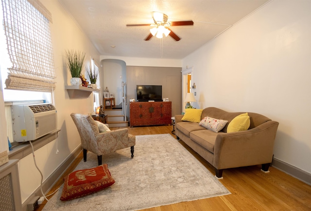 9005 Durham Ave, North Bergen, NJ 07047 - living area featuring ceiling fan, wood finished floors, arched walkways, cooling unit, and ornamental molding