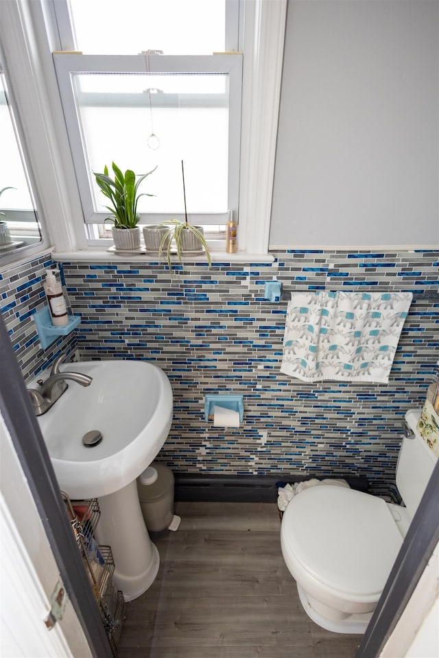 9005 Durham Ave, North Bergen, NJ 07047 - bathroom featuring tile walls, wood finished floors, and decorative backsplash