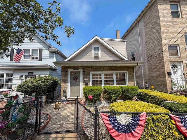 9005 Durham Ave, North Bergen, NJ 07047 - view of front of house featuring a fenced front yard, a gate, and stone siding