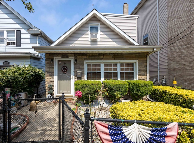 9005 Durham Ave, North Bergen, NJ 07047 - view of front of property featuring stone siding, a chimney, and a gate