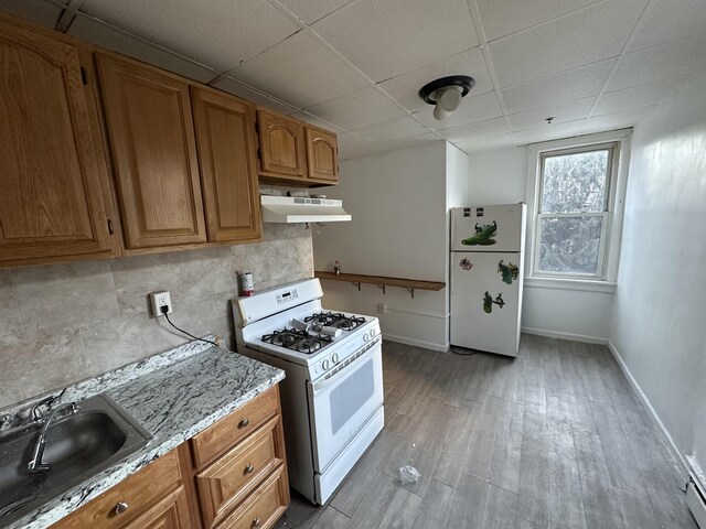 2512 Central Ave, Union City, NJ 08070 - kitchen featuring white appliances, a sink, under cabinet range hood, a drop ceiling, and brown cabinets