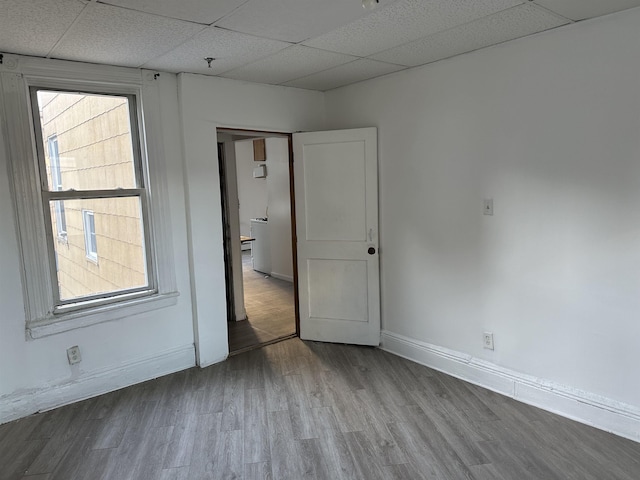2512 Central Ave, Union City, NJ 08070 - empty room featuring wood finished floors, a drop ceiling, and baseboards