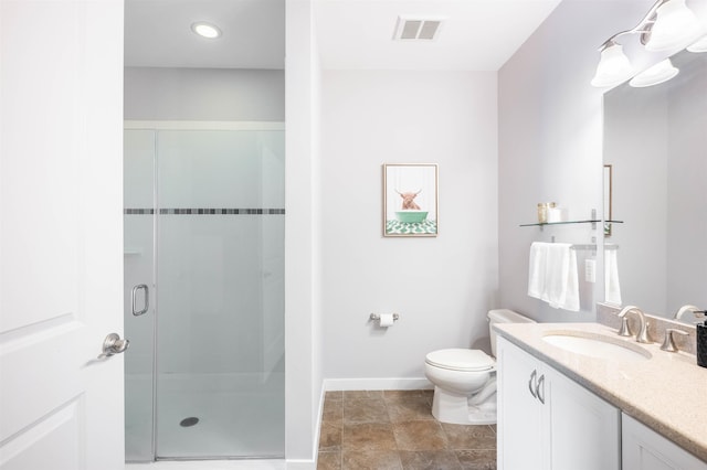 bathroom with toilet, vanity, visible vents, baseboards, and a shower stall