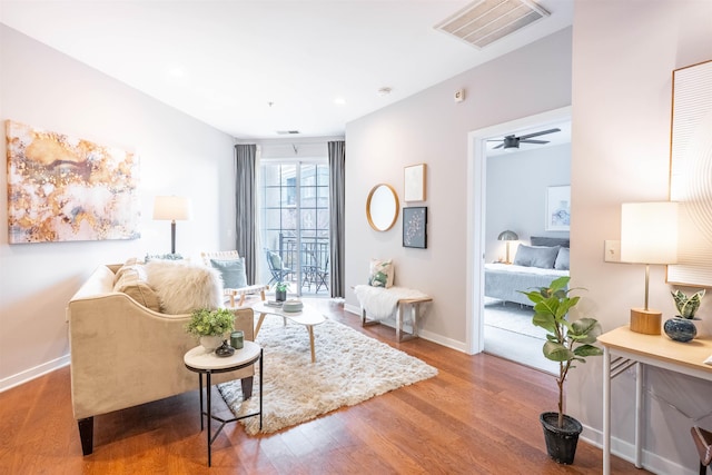 sitting room with recessed lighting, wood finished floors, a ceiling fan, visible vents, and baseboards