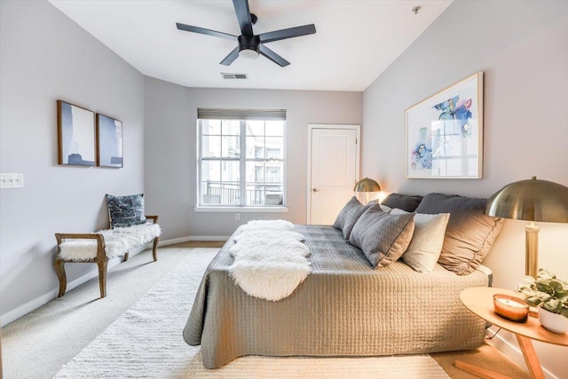 bedroom featuring light carpet, baseboards, visible vents, and a ceiling fan