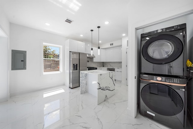 103 Poplar St Rear House, Rear House, Jersey City, NJ 07307 - washroom featuring stacked washer / drying machine, electric panel, recessed lighting, baseboards, and light marble finish flooring