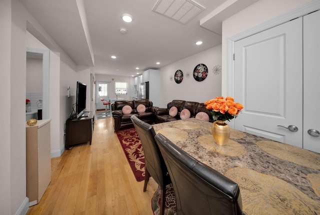 dining space with light wood-type flooring