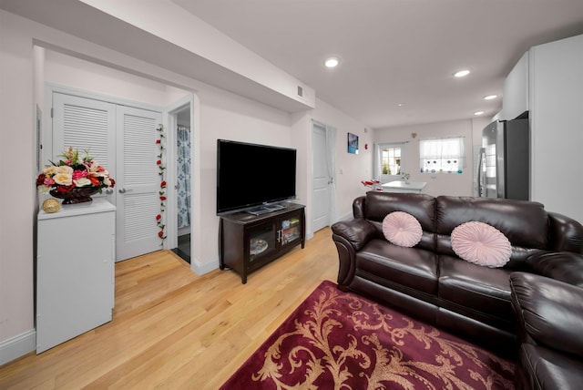 living room with light hardwood / wood-style flooring