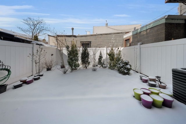 yard covered in snow featuring central AC unit