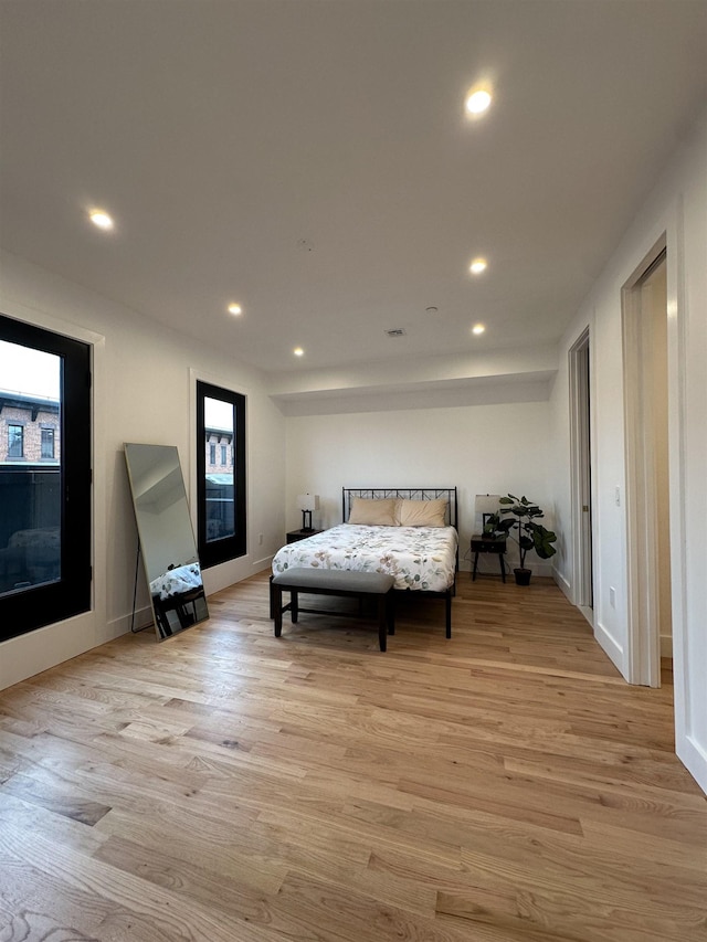 bedroom featuring light wood-type flooring, baseboards, and recessed lighting