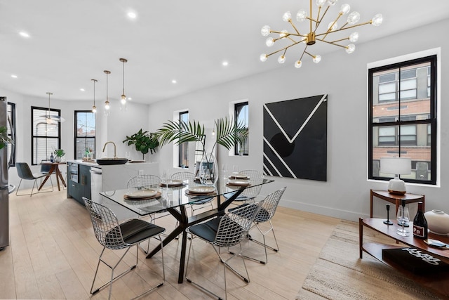 dining space featuring light wood-style flooring, recessed lighting, and baseboards