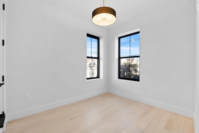 spare room featuring light hardwood / wood-style flooring