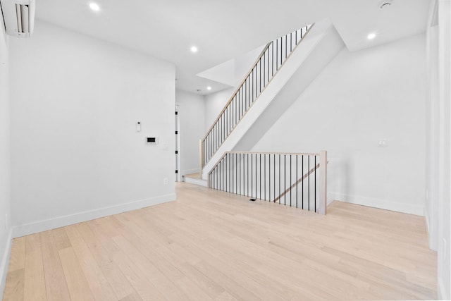 interior space featuring a wall unit AC and light hardwood / wood-style floors