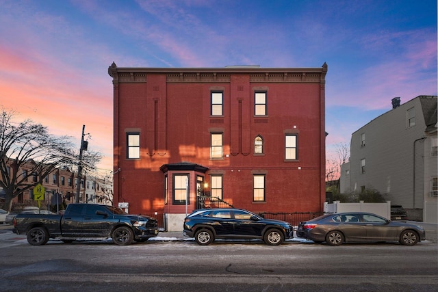 view of outdoor building at dusk