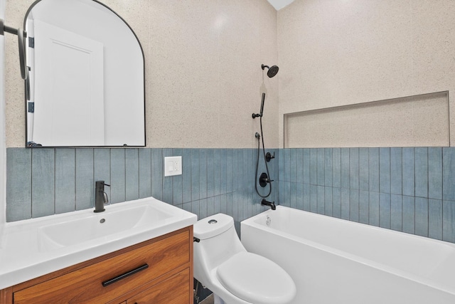 full bathroom featuring vanity, tiled shower / bath, and toilet