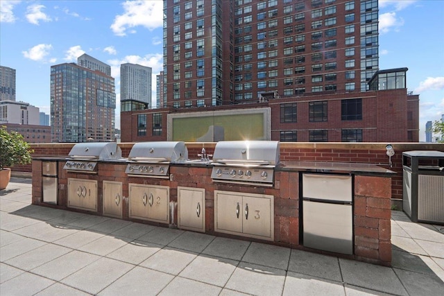 389 Washington St Unit 34E, Jersey City, NJ 07302 - view of patio featuring an outdoor kitchen and a view of skyline