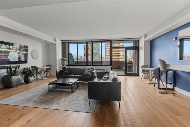 389 Washington St Unit 34E, Jersey City, NJ 07302 - living room with hardwood / wood-style floors and baseboards