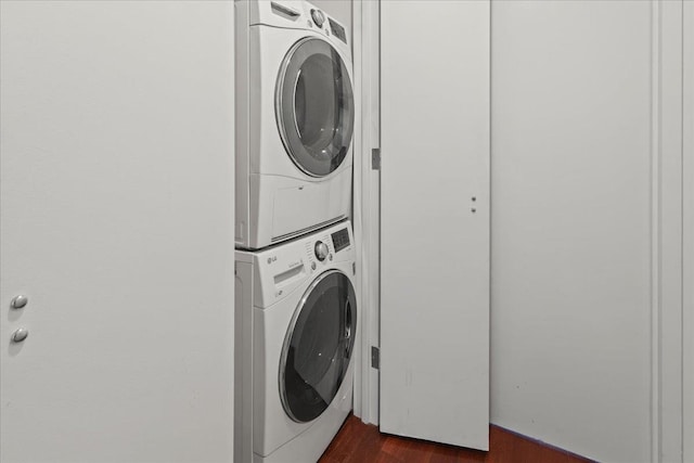 389 Washington St Unit 34E, Jersey City, NJ 07302 - laundry area with stacked washing machine and dryer and dark wood-type flooring