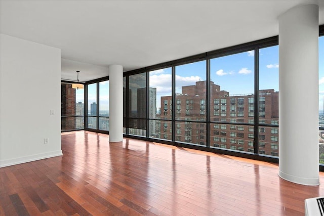 389 Washington St Unit 34E, Jersey City, NJ 07302 - unfurnished room with a view of city, hardwood / wood-style floors, and floor to ceiling windows