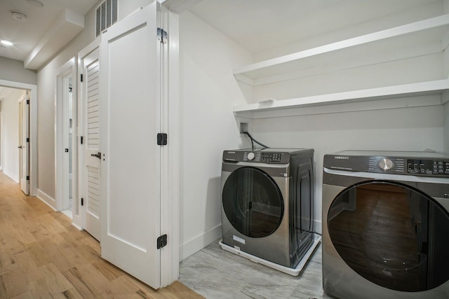 211 Summit Ave Unit 1, Jersey City, NJ 07304 - laundry room featuring light wood-style floors, laundry area, washing machine and dryer, baseboards, and visible vents