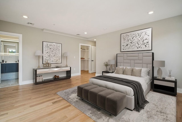 211 Summit Ave Unit 1, Jersey City, NJ 07304 - bedroom featuring ensuite bathroom, baseboards, visible vents, recessed lighting, and wood finished floors