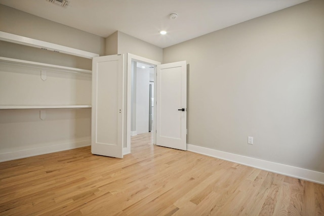 211 Summit Ave Unit 1, Jersey City, NJ 07304 - unfurnished bedroom with a closet, wood finished floors, visible vents, and baseboards