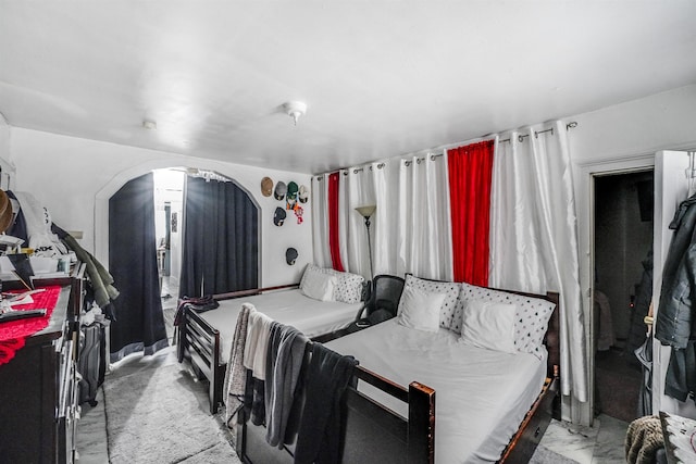 bedroom featuring arched walkways