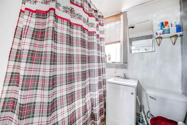 bathroom featuring vanity, a shower with shower curtain, and toilet