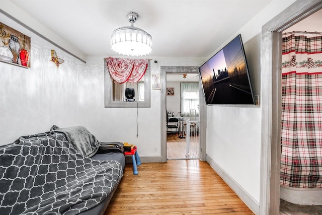 bedroom with hardwood / wood-style flooring and baseboards