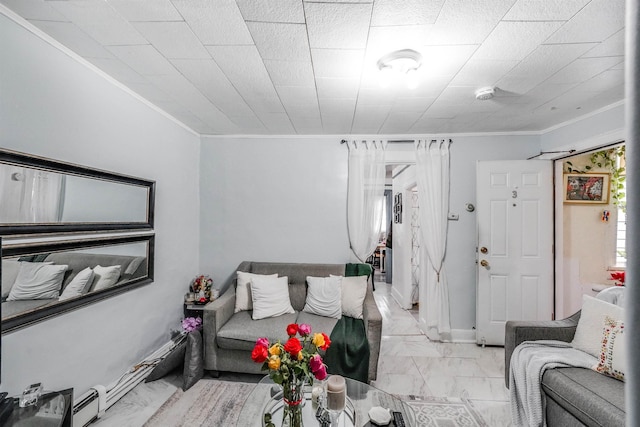 living area featuring marble finish floor, crown molding, and baseboards