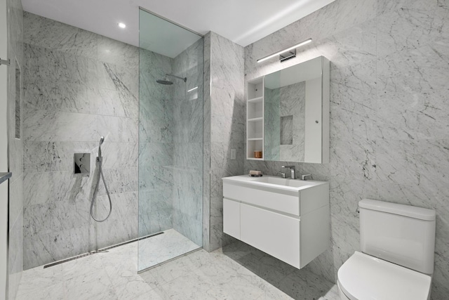 full bathroom with toilet, marble finish floor, a marble finish shower, tile walls, and vanity