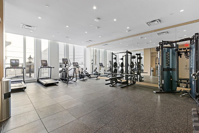 gym with recessed lighting, visible vents, and expansive windows