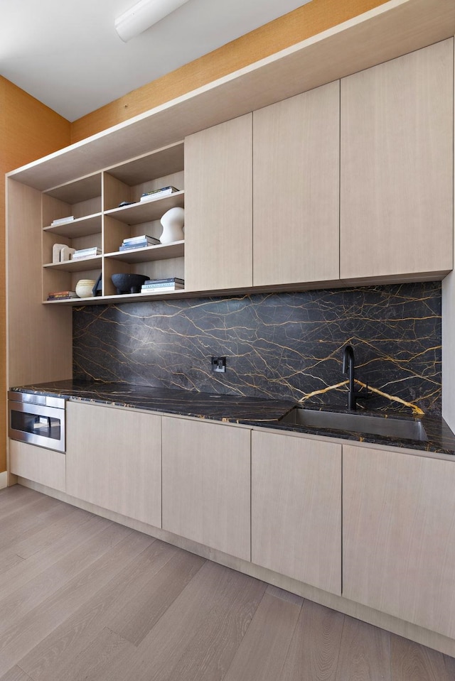 interior space featuring modern cabinets, light wood-type flooring, and open shelves