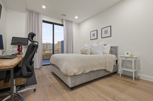 bedroom featuring access to exterior and light hardwood / wood-style floors