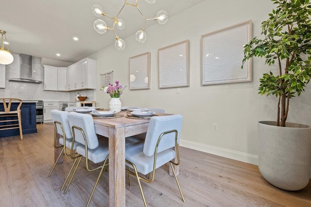 dining room with a chandelier and light hardwood / wood-style floors