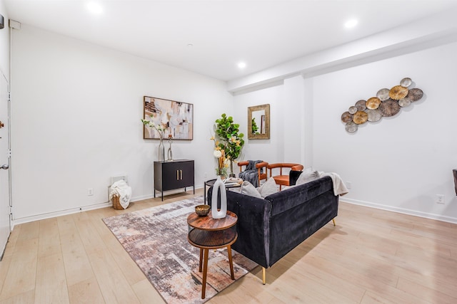 living room with light wood finished floors, baseboards, and recessed lighting