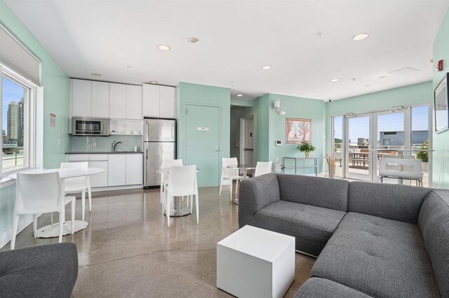217 Newark Ave Unit 210, Jersey City, NJ 07302 - living room featuring speckle patterned floor and recessed lighting