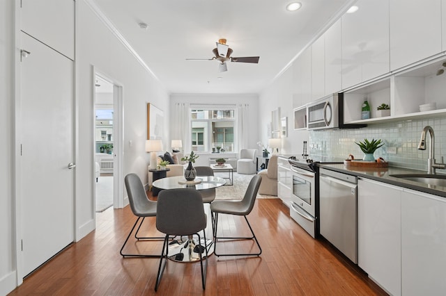 217 Newark Ave Unit 210, Jersey City, NJ 07302 - dining area featuring crown molding, wood finished floors, a ceiling fan, and recessed lighting