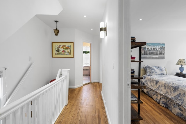 83 W 38th St, Bayonne, NJ 07002 - hallway with an upstairs landing, wood finished floors, radiator, and recessed lighting