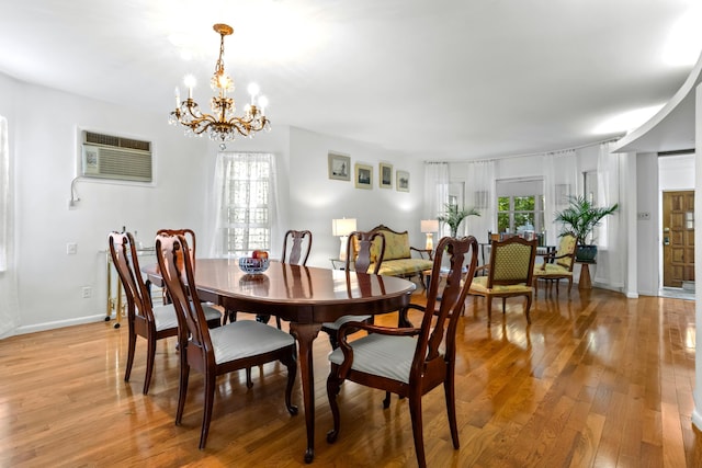 83 W 38th St, Bayonne, NJ 07002 - dining room with a wall mounted AC, a chandelier, and light wood-style flooring
